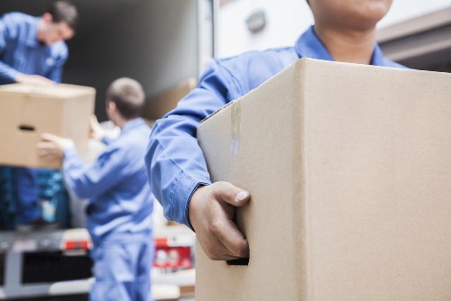 Professional flat removals team preparing apartment furniture in Acton