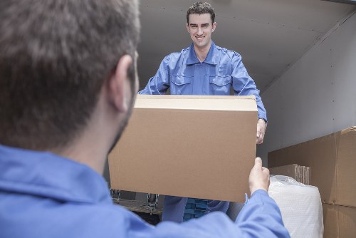 Acton movers carefully loading furniture during a local relocation