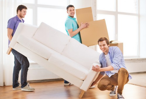 Removals team packing and loading furniture for an Acton home move