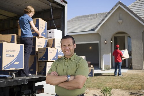 Movers preparing household belongings for transport in Acton