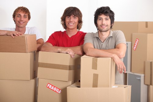 Commercial movers handling office desks and workstations in a local building move