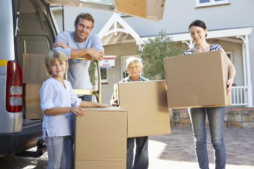 Acton moving crew handling boxes and fragile items with care